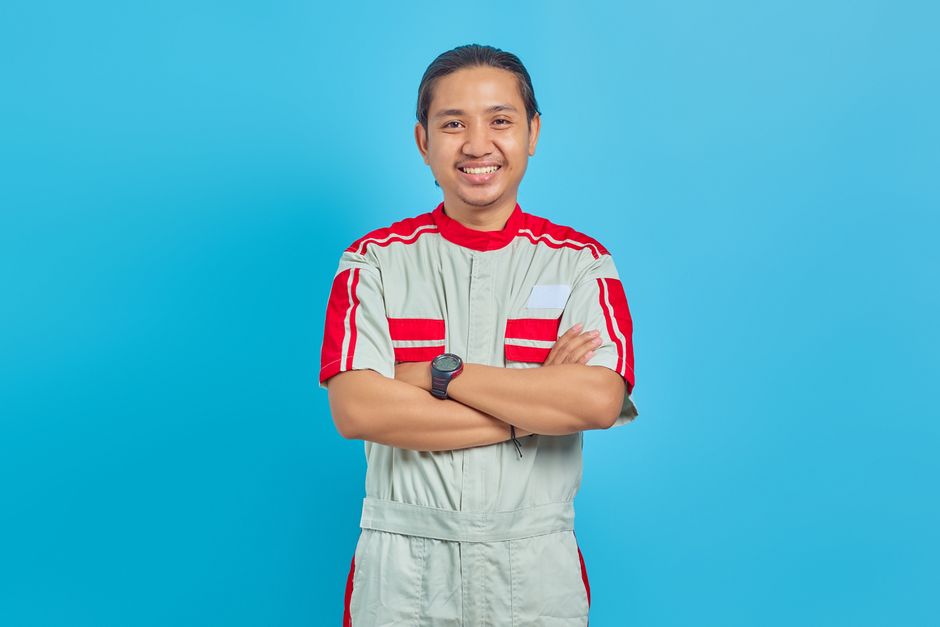 Friendly HVAC repairman smiling after a successful service